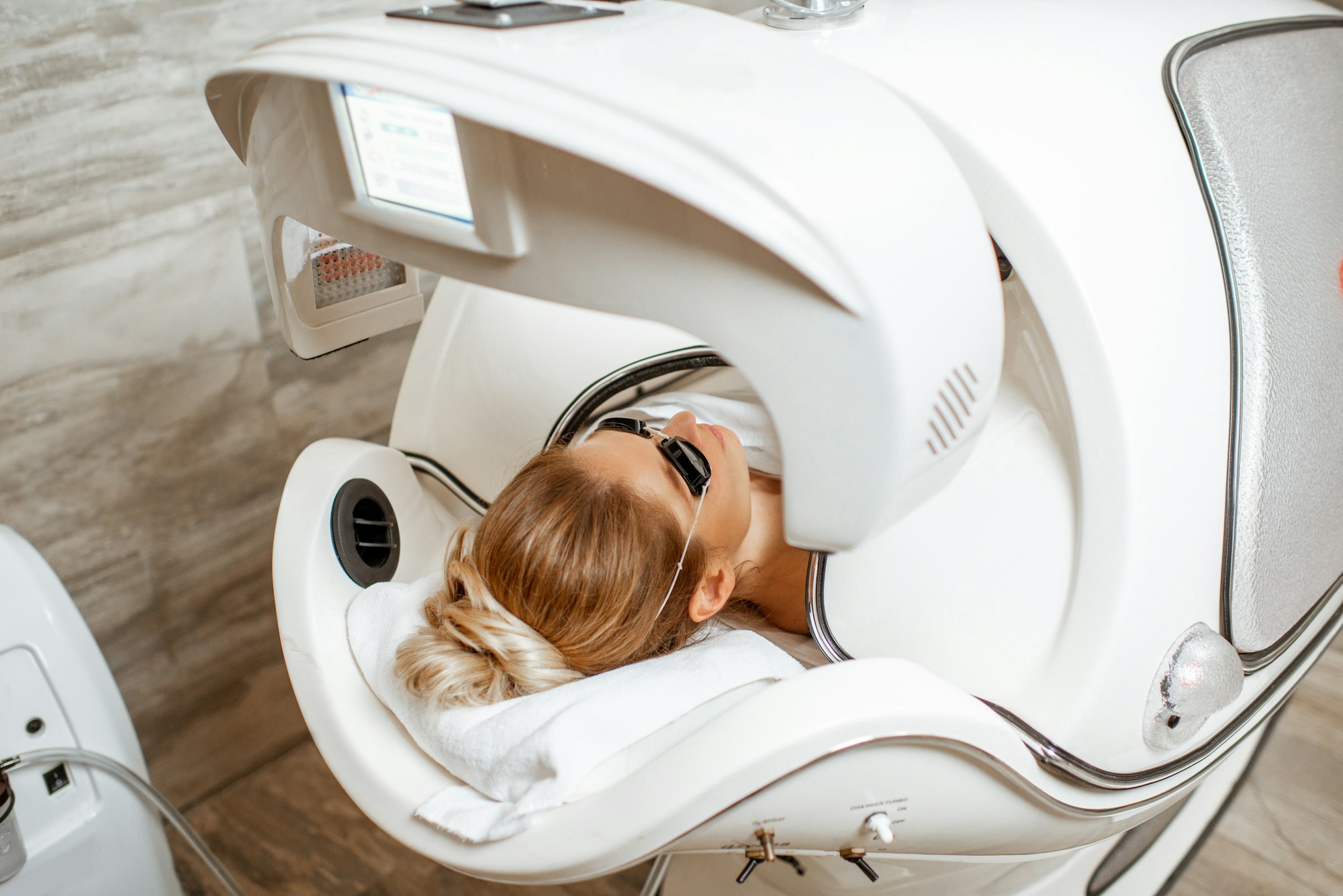 Woman in the spa capsule at the beauty salon